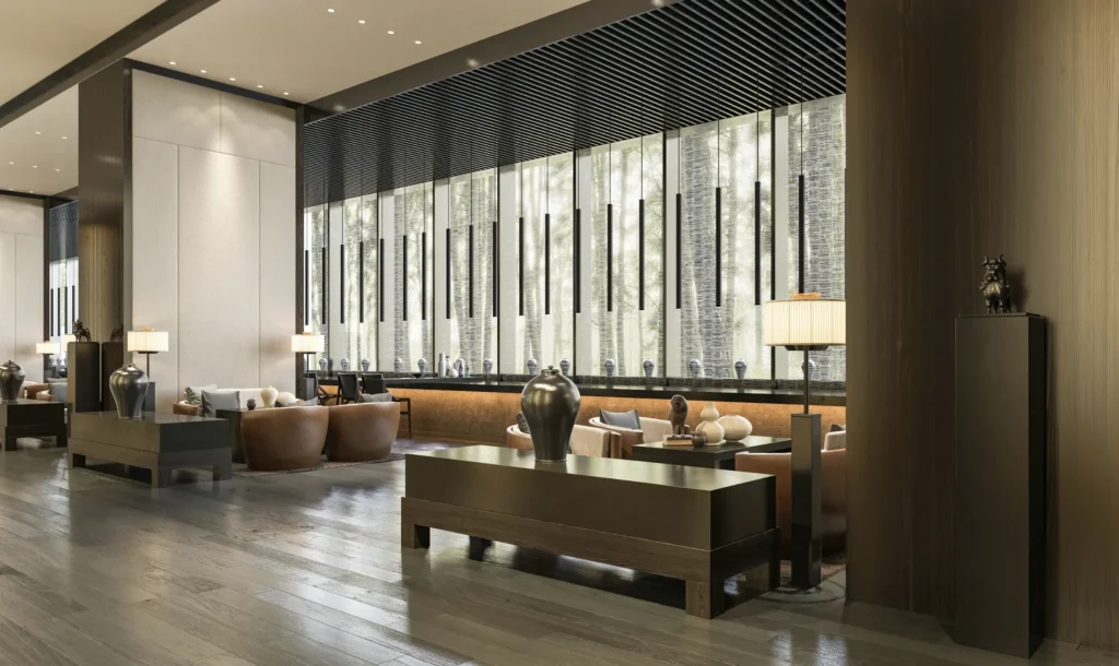 Upscale commercial lobby with designer furnishings, statement lighting, and natural light from tall windows overlooking trees.